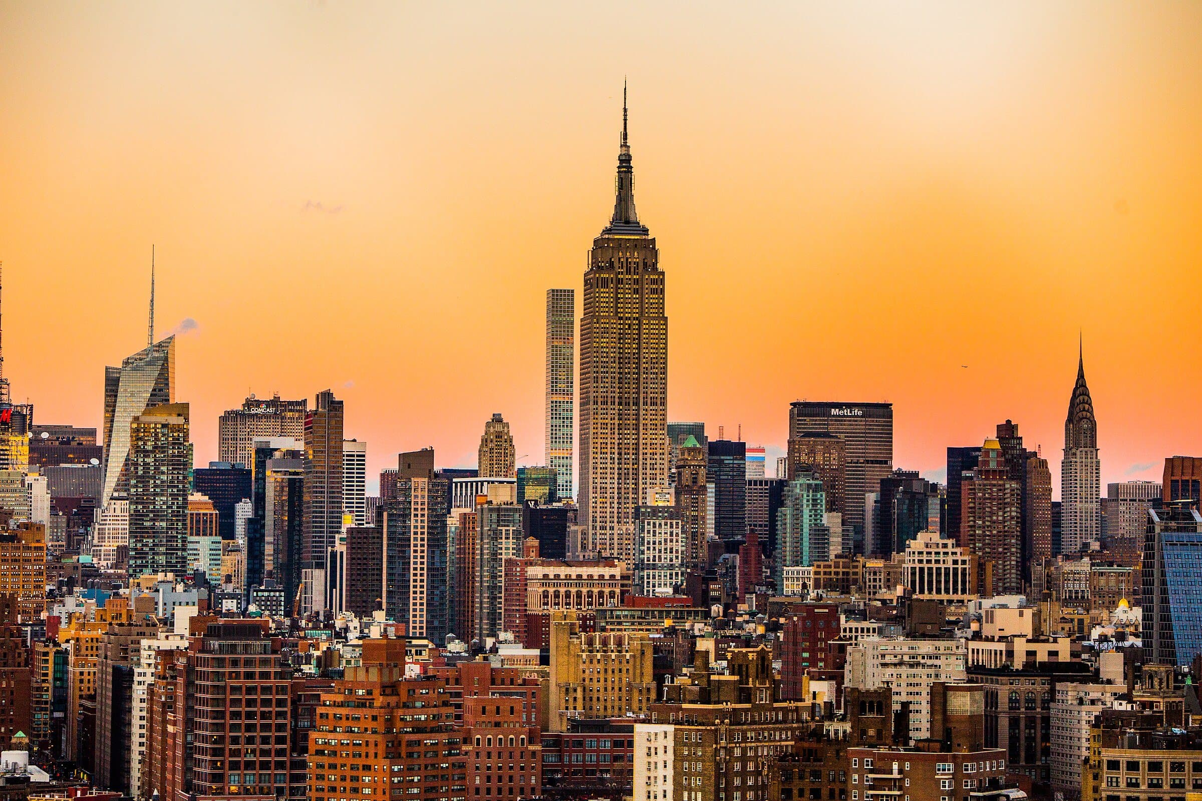 Midtown Manhattan at sunset, with the Empire State Building above the rooftops