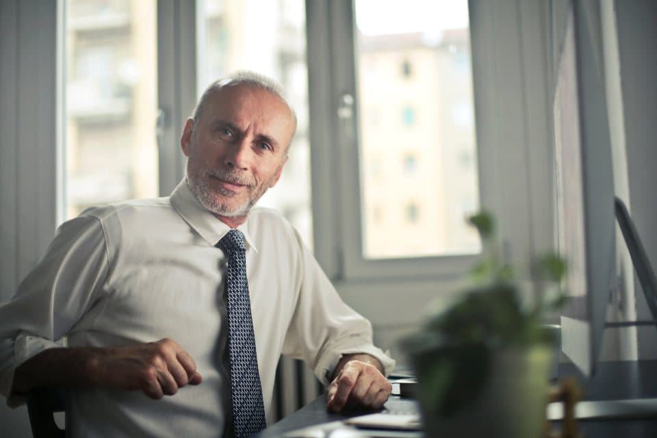 Senior executive at his desk by an office window