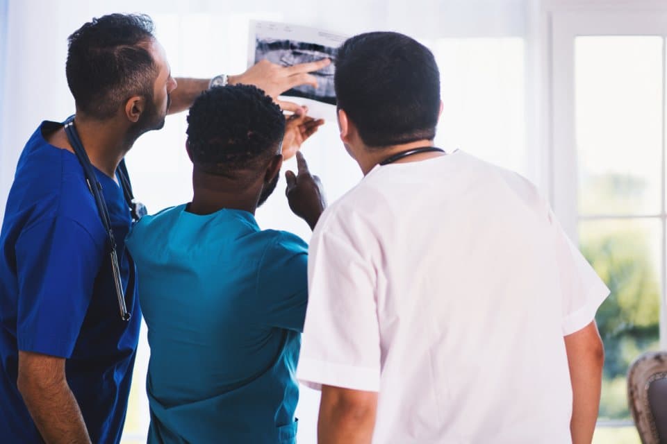 Clinicians reviewing an x-ray together